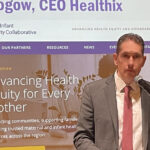 CEO Todd Rogow speaks at the podium