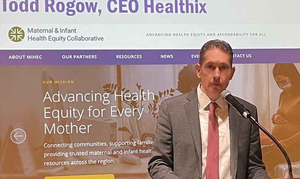 CEO Todd Rogow speaks at the podium