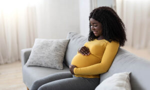 Smiling pregnant woman at home